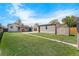 Spacious backyard with lush green lawn, shed, and detached garage with solar panels at 2235 W 46Th Ave, Denver, CO 80211