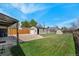Large backyard showcasing the detached garage, lush lawn, and gravel area at 2235 W 46Th Ave, Denver, CO 80211