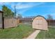 Spacious backyard featuring lush green grass and two outdoor storage sheds at 2235 W 46Th Ave, Denver, CO 80211