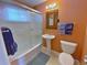 Bathroom featuring a shower and tub, a pedestal sink, a toilet, and complementary colored walls at 2235 W 46Th Ave, Denver, CO 80211