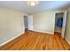 Bright bedroom with hardwood floors, two doors, and a built in closet with clothes at 2235 W 46Th Ave, Denver, CO 80211