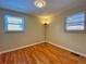 Bedroom with hardwood floors and natural light streaming through two windows at 2235 W 46Th Ave, Denver, CO 80211
