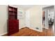 Bedroom featuring hardwood floors, built in shelving, and a window, offering ample storage and natural light at 2235 W 46Th Ave, Denver, CO 80211