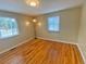 Bright bedroom with gleaming hardwood floors, large windows, and stylish lighting fixture at 2235 W 46Th Ave, Denver, CO 80211