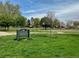 Sign at Chaffee Park with green lawns, mature trees and a basketball court in the background at 2235 W 46Th Ave, Denver, CO 80211
