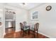 Bright dining area with hardwood floors, a glass table with seating for four, and natural light at 2235 W 46Th Ave, Denver, CO 80211