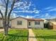 Charming home with a well-maintained lawn, complemented by a beautiful blue sky filled with fluffy white clouds at 2235 W 46Th Ave, Denver, CO 80211