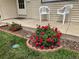Inviting front porch with red roses, white chairs, and well maintained landscaping at 2235 W 46Th Ave, Denver, CO 80211
