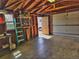 Spacious garage featuring exposed wood beams, storage shelves, and access to the backyard at 2235 W 46Th Ave, Denver, CO 80211