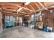 Functional garage interior with exposed wood framing, concrete floor, workbench, and storage shelves at 2235 W 46Th Ave, Denver, CO 80211