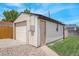 Detached garage features modern siding, a garage door, and a walk-in door at 2235 W 46Th Ave, Denver, CO 80211