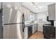 Updated kitchen showcasing stainless steel appliances, granite counters, and modern lighting at 2235 W 46Th Ave, Denver, CO 80211