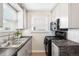 Galley kitchen featuring gray cabinets, modern countertops, subway tile backsplash, and stainless sink at 2235 W 46Th Ave, Denver, CO 80211