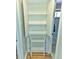 Open linen closet reveals storage shelves with a view through to an adjacent bathroom at 2235 W 46Th Ave, Denver, CO 80211