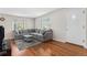 Cozy living room featuring hardwood floors, ample natural light, and a comfortable gray sectional at 2235 W 46Th Ave, Denver, CO 80211