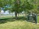 Sign for Rocky Mountain Lake Park with grass, trees, and lake view at 2235 W 46Th Ave, Denver, CO 80211
