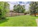 Expansive grassy backyard enclosed by a tall wooden fence, offering privacy and space at 8652 Aberdeen Cir, Highlands Ranch, CO 80130