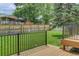Spacious backyard features a well-maintained lawn, a wood fence, and iron railings offering privacy and security at 8652 Aberdeen Cir, Highlands Ranch, CO 80130