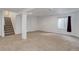 Finished basement featuring neutral carpet, a window for natural light, and stairway to upper floors at 8652 Aberdeen Cir, Highlands Ranch, CO 80130