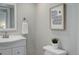 Bathroom features a white vanity, sink, and a minimalist design with a focus on clean lines and natural lighting at 8652 Aberdeen Cir, Highlands Ranch, CO 80130