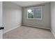 A simple bedroom with neutral walls, carpeting, and a window for natural light at 8652 Aberdeen Cir, Highlands Ranch, CO 80130