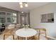 Cozy dining area with contemporary table and chairs adjacent to the living room and entryway at 8652 Aberdeen Cir, Highlands Ranch, CO 80130