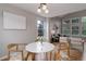Bright dining area with contemporary table and chairs, and views of the living space at 8652 Aberdeen Cir, Highlands Ranch, CO 80130