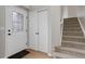 Inviting entryway featuring a decorative glass front door, coat closet, and carpeted stairs at 8652 Aberdeen Cir, Highlands Ranch, CO 80130