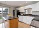 Functional kitchen features white cabinets, dark countertops, and an island at 8652 Aberdeen Cir, Highlands Ranch, CO 80130
