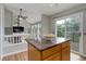 Kitchen island with stone countertop, open layout to backyard deck and living area, perfect for entertaining guests at 8652 Aberdeen Cir, Highlands Ranch, CO 80130