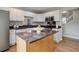 Bright kitchen with stainless steel appliances, island, and white cabinets, perfect for cooking and entertaining at 8652 Aberdeen Cir, Highlands Ranch, CO 80130