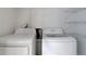 Laundry area showcases a washer, dryer, and wire shelving for added convenience at 8652 Aberdeen Cir, Highlands Ranch, CO 80130