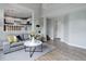 Bright, open living room with neutral decor, connecting seamlessly with the kitchen and upper levels for easy living at 8652 Aberdeen Cir, Highlands Ranch, CO 80130