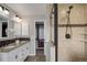 Modern main bathroom with dual sinks, tiled shower, granite countertops, and updated fixtures at 8652 Aberdeen Cir, Highlands Ranch, CO 80130
