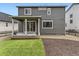 Back of home with a covered patio and manicured backyard; perfect for relaxation at 1373 E Witherspoon Dr, Elizabeth, CO 80107