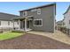 Back of home with a covered patio and manicured backyard; perfect for relaxation at 1373 E Witherspoon Dr, Elizabeth, CO 80107