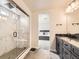 Primary bathroom with a glass-enclosed shower, a double vanity, and a view to the main bedroom at 1373 E Witherspoon Dr, Elizabeth, CO 80107