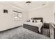 Bedroom with tray ceilings, a comfortable bed, soft gray carpet, and a street view at 1373 E Witherspoon Dr, Elizabeth, CO 80107