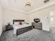 Bedroom with tray ceilings, a comfortable bed, soft gray carpet, and modern furnishings at 1373 E Witherspoon Dr, Elizabeth, CO 80107