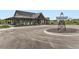 The Homestead clubhouse exterior with sign, landscaping and entrance at 1373 E Witherspoon Dr, Elizabeth, CO 80107