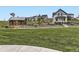 A view of the community park with a lush lawn and vintage-style buildings at 1373 E Witherspoon Dr, Elizabeth, CO 80107