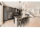 Modern kitchen with a center island, sleek black cabinetry, stainless steel appliances, and contemporary pendant lighting at 1373 E Witherspoon Dr, Elizabeth, CO 80107