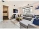 Bright living room featuring a large gray sectional, a decorative rug, and views to the exterior at 1373 E Witherspoon Dr, Elizabeth, CO 80107