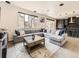 Bright living room featuring a large gray sectional, a decorative rug, and a modern open-concept kitchen at 1373 E Witherspoon Dr, Elizabeth, CO 80107
