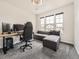 Bright office space with a comfortable gray sofa and a modern computer setup at 1373 E Witherspoon Dr, Elizabeth, CO 80107
