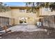 A backyard featuring a sliding glass door leading to a dining area and a concrete patio at 1191 S Troy St, Aurora, CO 80012