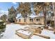 Ranch home with a brick exterior, raised garden beds, and snow on the ground at 4035 E 16Th Ave, Denver, CO 80220