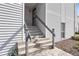 Exterior front entrance with security door, stairs, and gray handrails for a contemporary look at 11103 E Alameda Ave # 201, Aurora, CO 80012