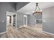 Spacious living room with wood plank flooring and a modern lighting fixture at 11103 E Alameda Ave # 201, Aurora, CO 80012