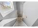 Carpeted staircase ascends past a window, offering natural light to the upper level at 11103 E Alameda Ave # 201, Aurora, CO 80012